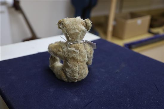 A vintage Steiff c1908 with button in ear, some hair loss generally, height 20cm